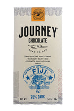 Load image into Gallery viewer, A large size packaged Journey Chocolate bar in an off-white cardboard box with wavy US postal service lines across the top, lower sides and bottom of the box. A gold foil postage stamp style seal with a cacao pod in the middle seals the box, with the word “Limited” in cursive in wavy concentric circles around the image and the word “Release” at the bottom. The Journey Chocolate logo is centered on the bar and a Fiji 70% dark stamp centered on the bottom, net weight 2.47 oz or 70 grams.
